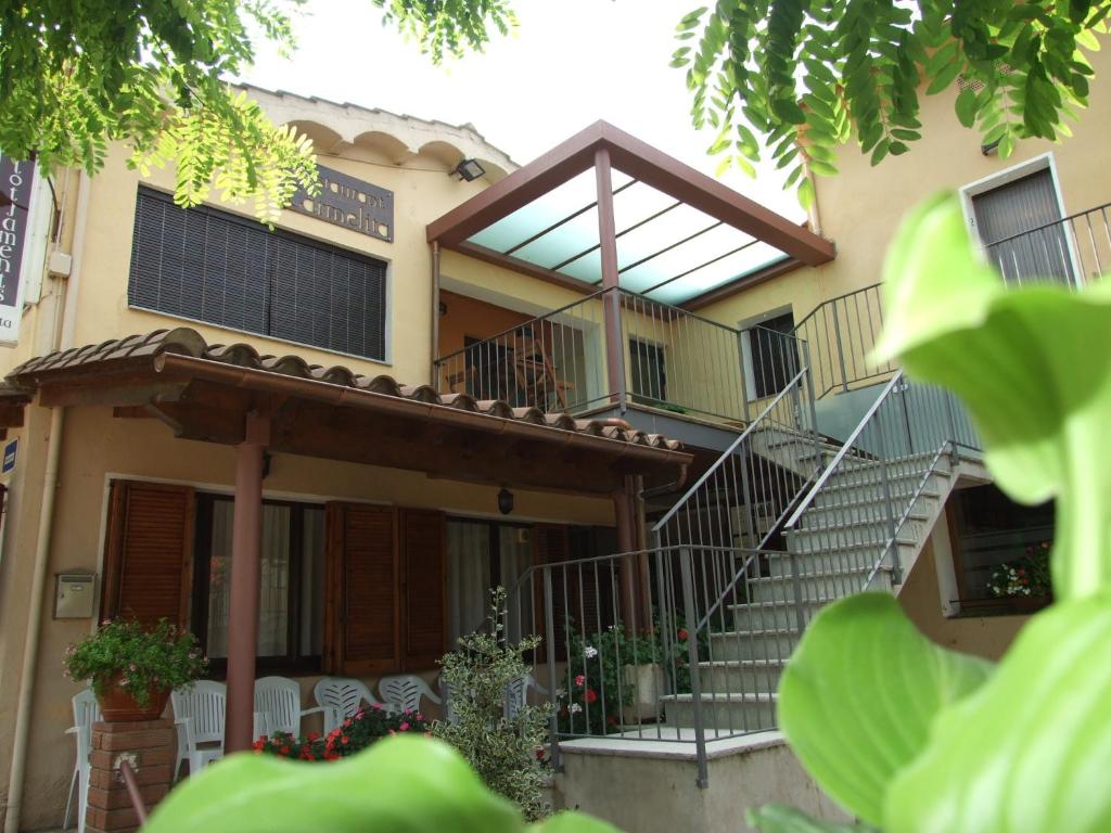 a house with a staircase in front of it at Carmelita in Sant Privat de Bas