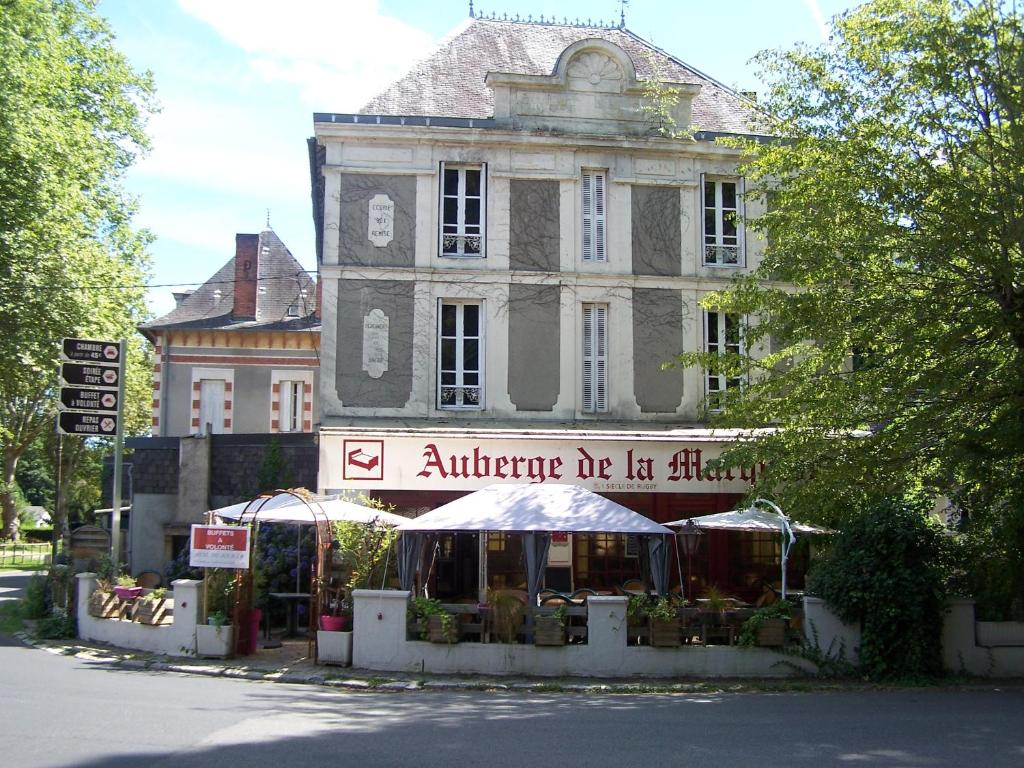 an old building with a market in front of it at Auberge de la marquise in Arnac-Pompadour