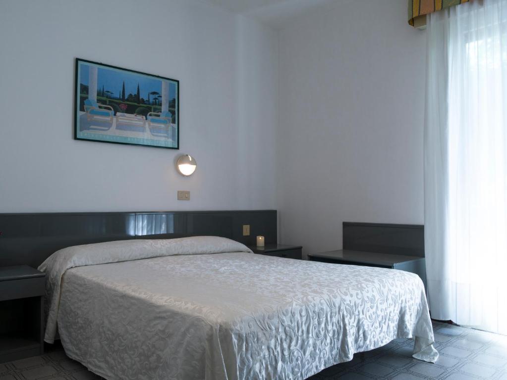 Postel nebo postele na pokoji v ubytování Hotel Casa Mia