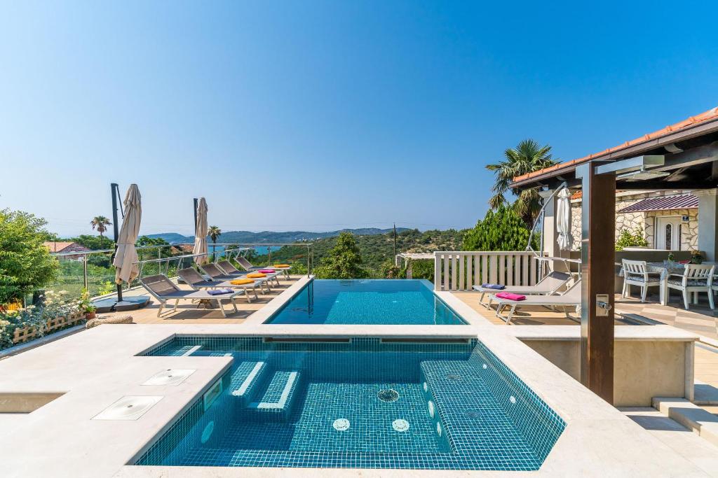 a swimming pool in a villa with a view at Villa La Vagabonda in Orasac