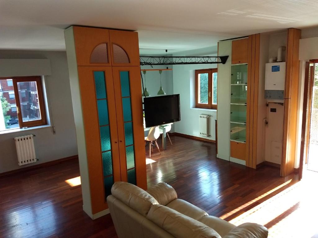 a living room with a couch and a television at Cozy Open Space in Via Castel del Monte in Andria