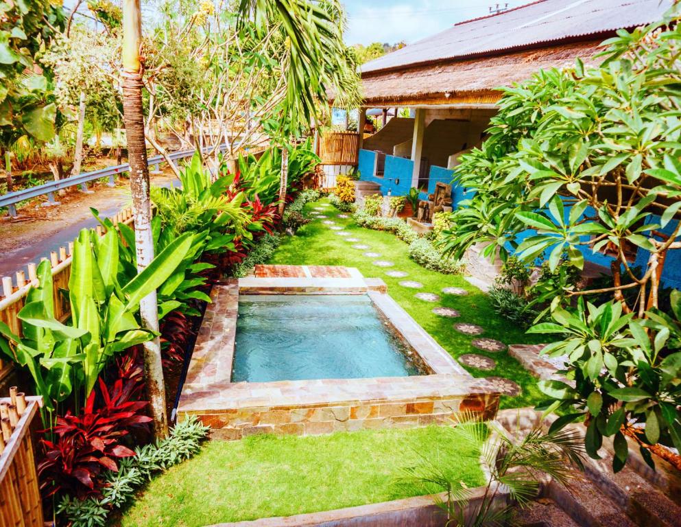 a swimming pool in the yard of a house at Balangan Inn Surf Homestay in Jimbaran