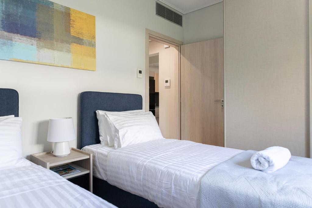 A bed or beds in a room at Olygreen Athens Residences