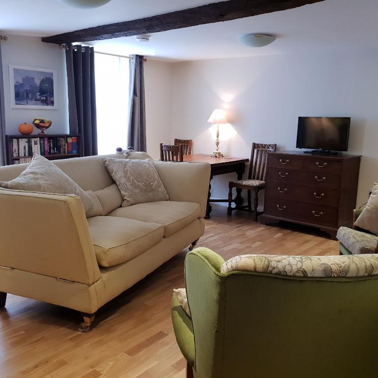 a living room with a couch and chairs and a table at 138a Old Star & Garter in Ludlow