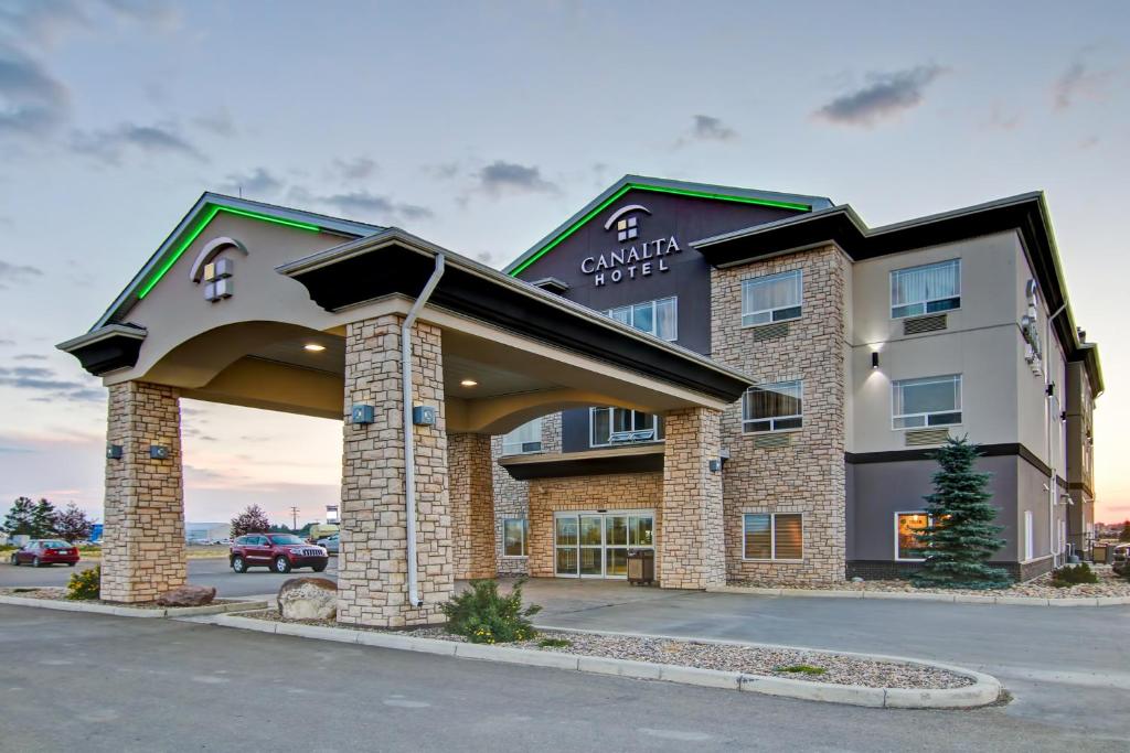 a rendering of a hotel with a building at Canalta Hotel Assiniboia in Assiniboia