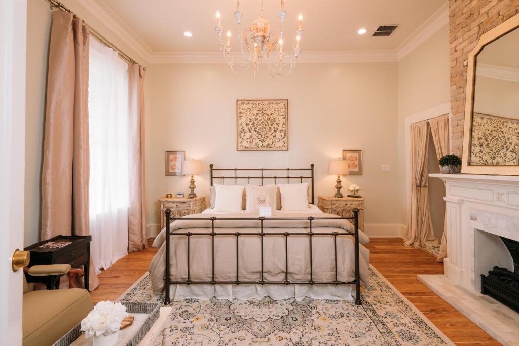 a bedroom with a bed and a fireplace at The Kendall in Boerne