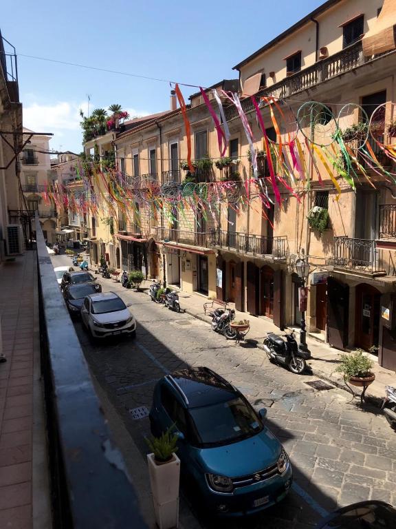 a street with cars parked in front of buildings at Corso Garibaldi 22 apartment in Paola