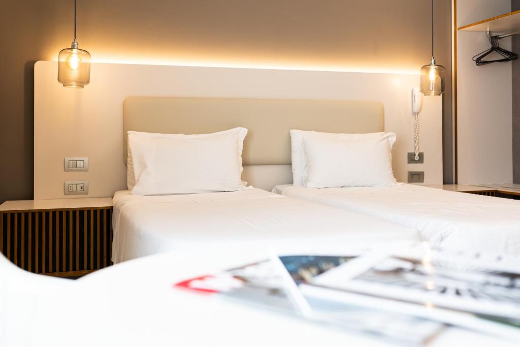 Postel nebo postele na pokoji v ubytování Hotel Milano Castello
