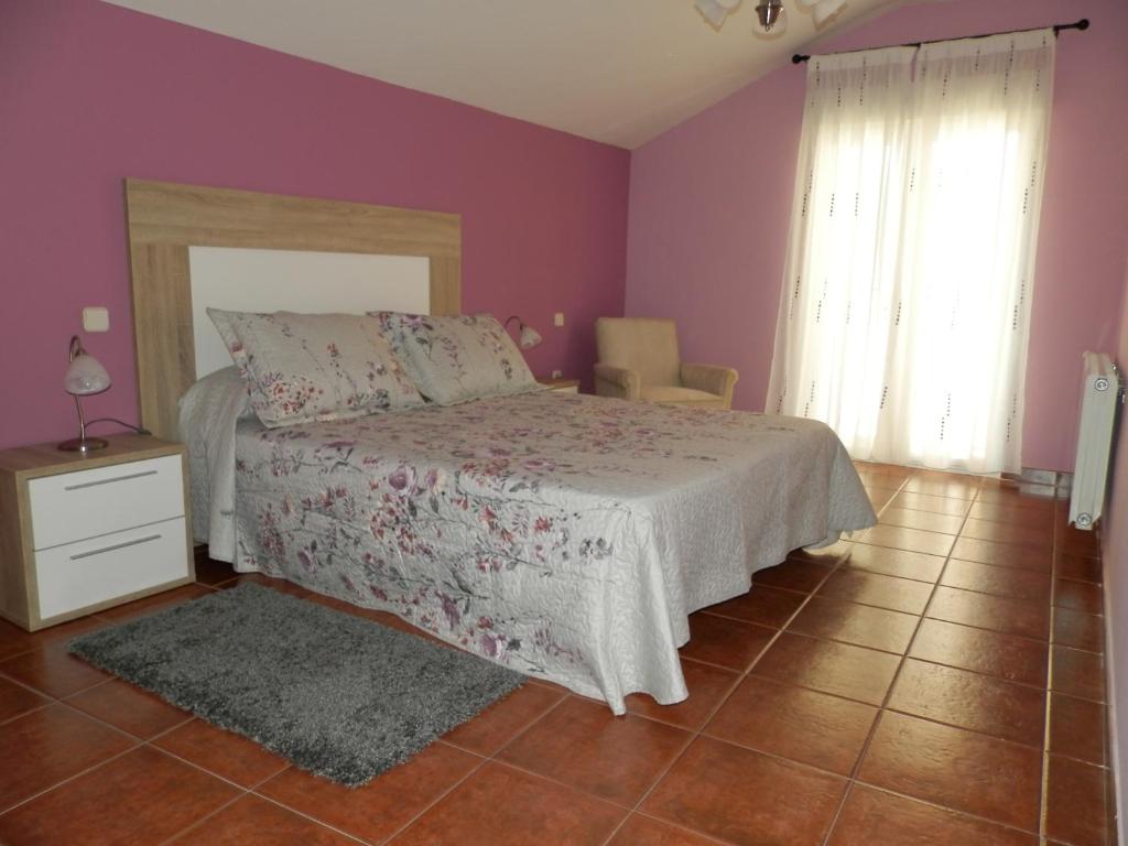 una camera con letto e parete viola di LA CORRALA a Segovia