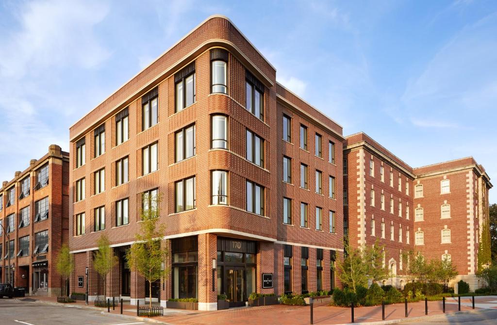 a large brick building on a city street at The Whitney Hotel Boston in Boston