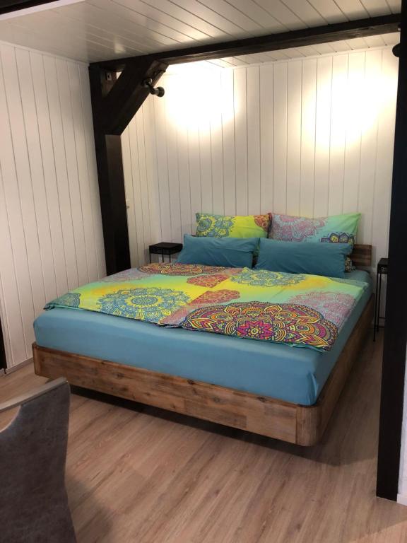 a bed with a wooden frame in a room at Ferienanlage Vorauf - be happy in Siegsdorf