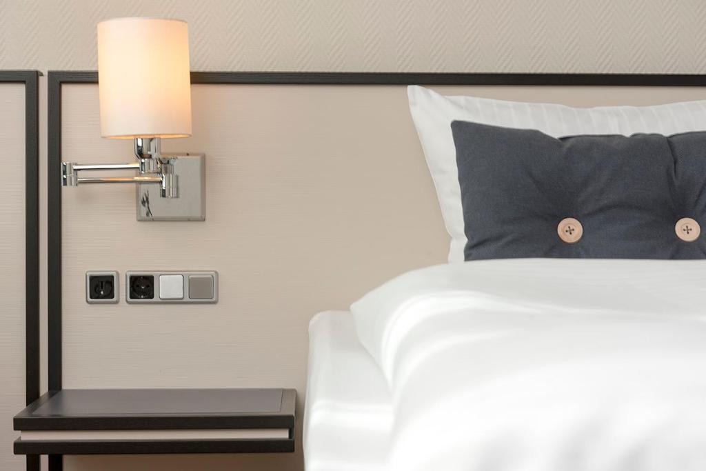 Postel nebo postele na pokoji v ubytování Seminaris Hotel Lüneburg