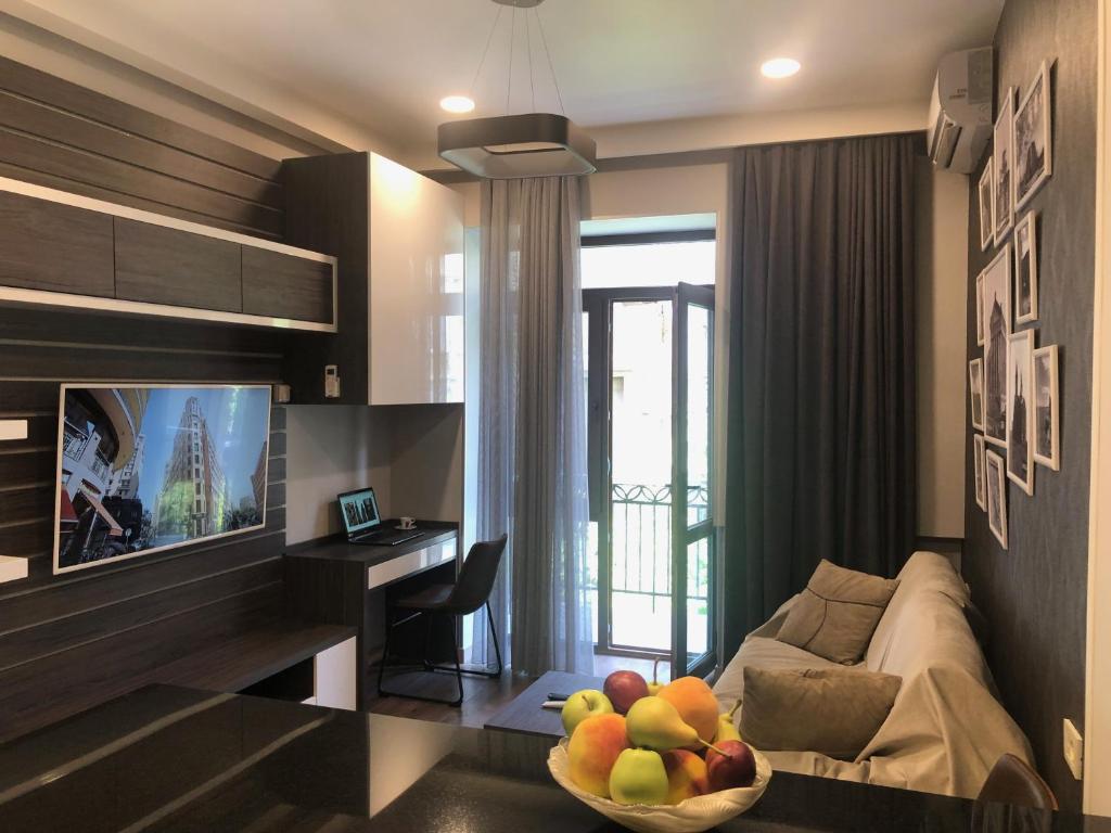 a living room with a couch and a bowl of fruit at Apartment on Moskovyan 31 in Yerevan