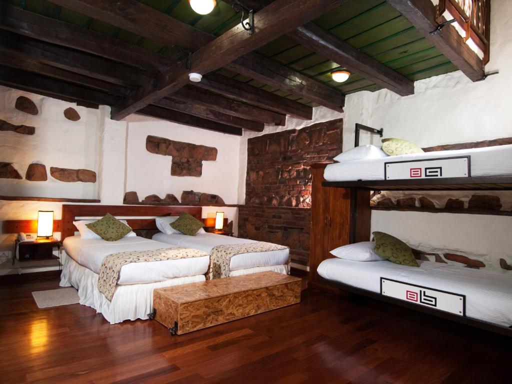 Postel nebo postele na pokoji v ubytování Hotel Muisca