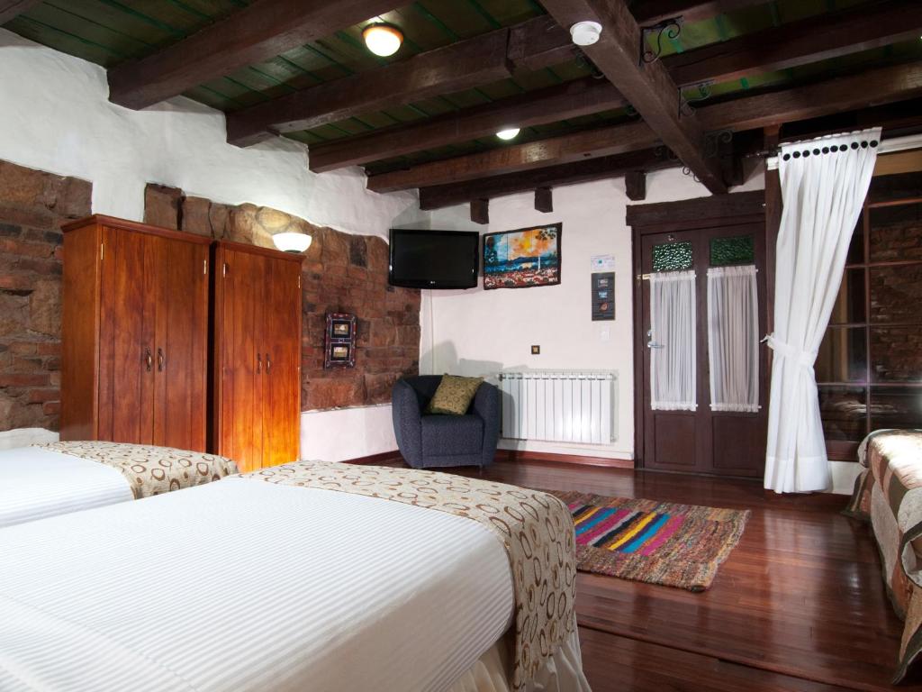 Postel nebo postele na pokoji v ubytování Hotel Muisca