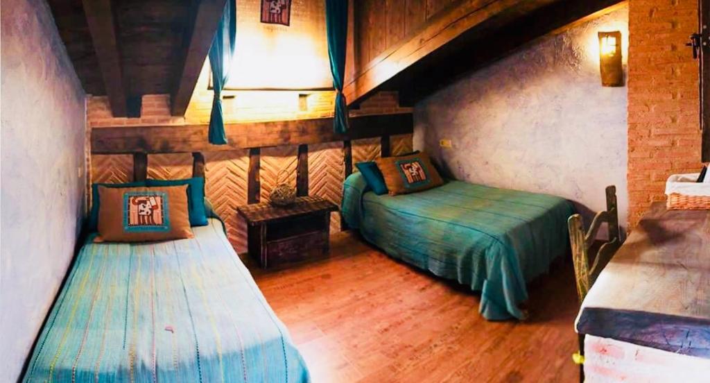 En eller flere senge i et værelse på Casa rural La Antigua Vaqueria