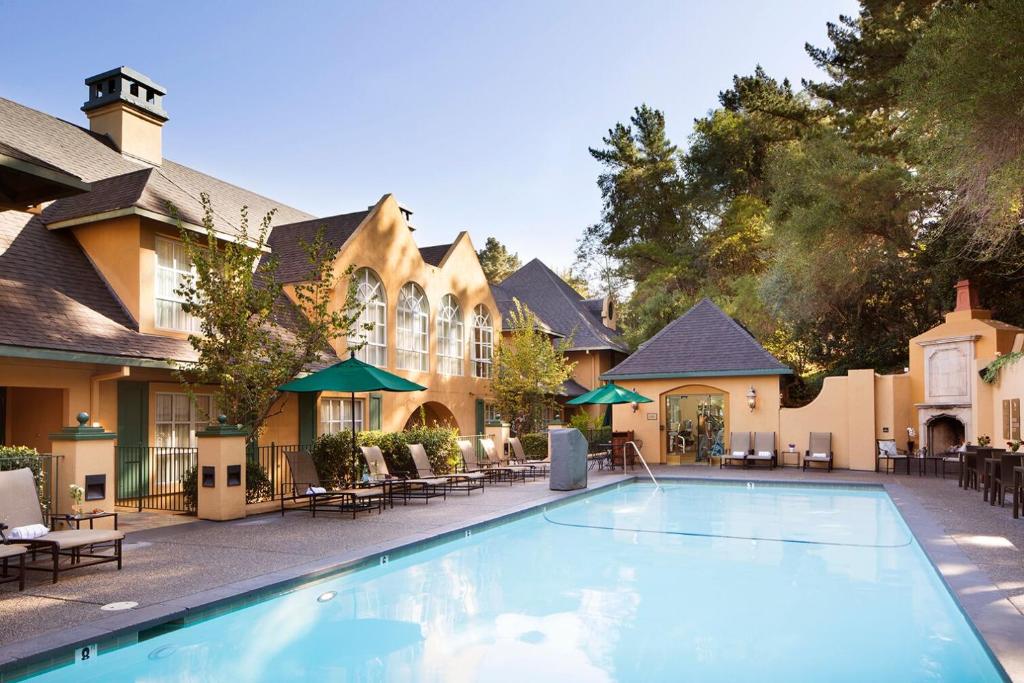 uma piscina em frente a um hotel com mesas e cadeiras em Lafayette Park Hotel & Spa em Lafayette