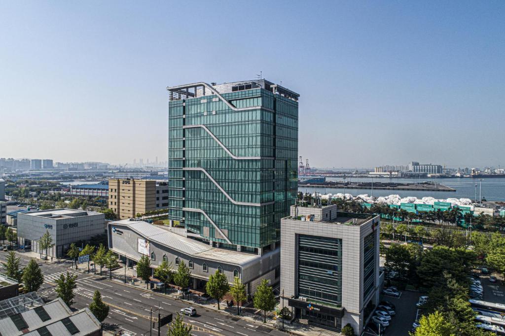 een hoog glazen gebouw in het midden van een stad bij Harbor Park Hotel in Incheon