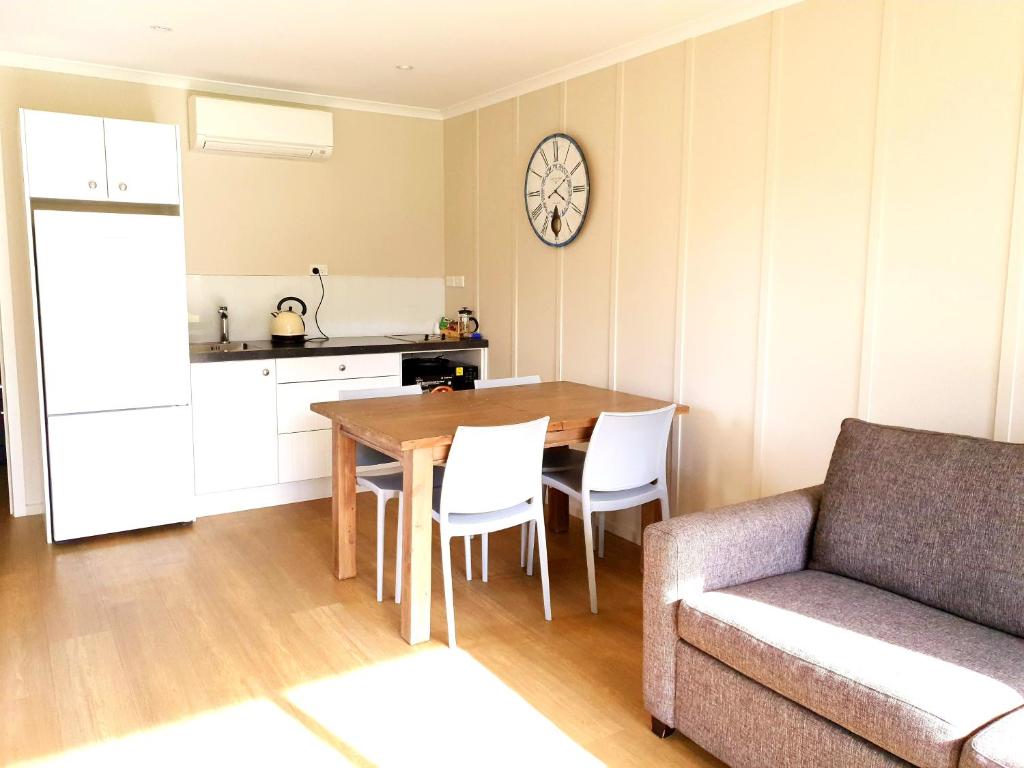 a living room with a couch and a table and chairs at Braxmere Lodge in Turangi