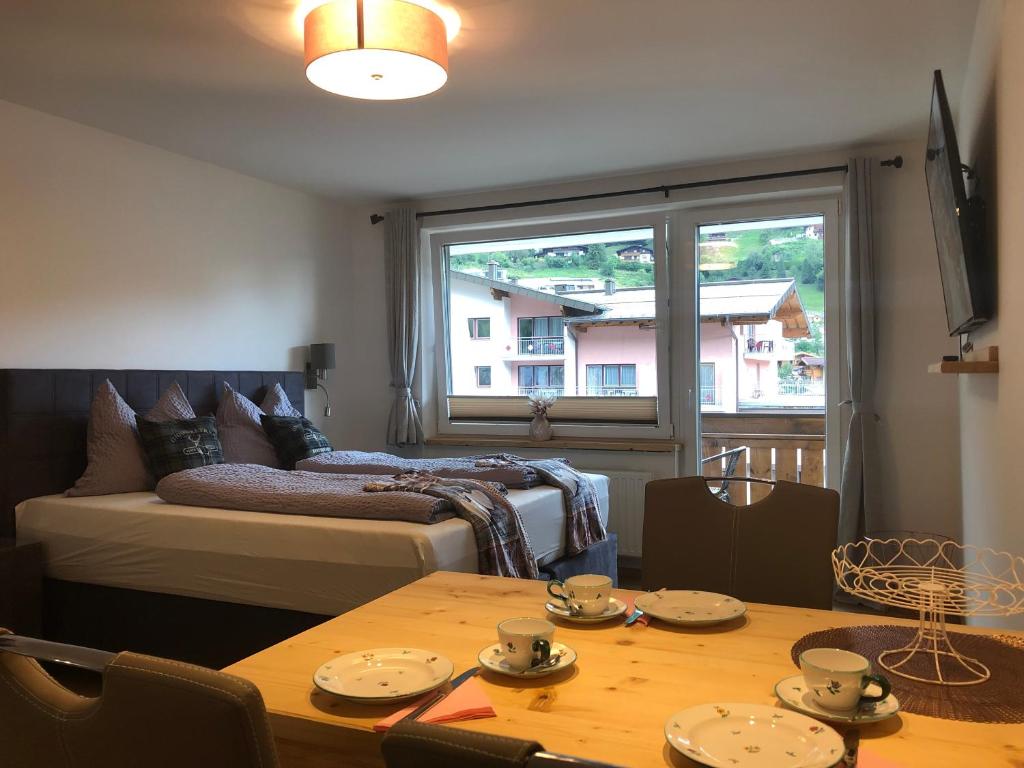a room with a bed and a table with plates on it at Julia in Kaprun