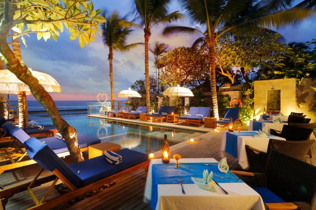 a resort with a swimming pool and palm trees at Sagara Candidasa in Candidasa