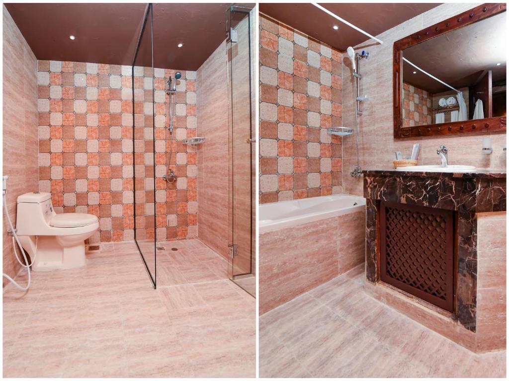 a bathroom with a shower and a toilet and a sink at Ras Al Khaimah Hotel in Ras al Khaimah