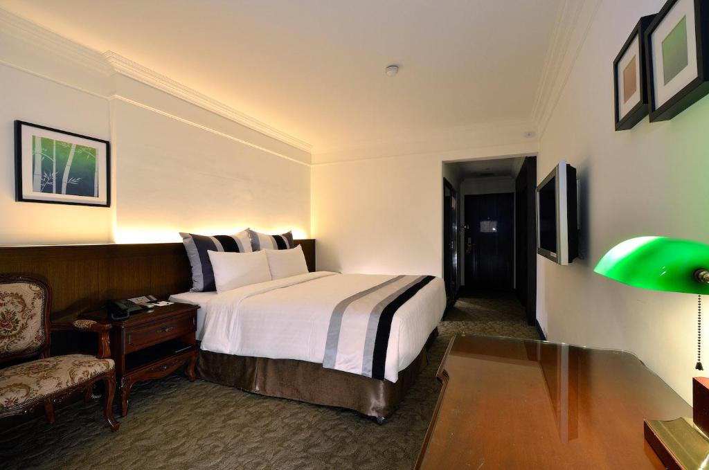 Postel nebo postele na pokoji v ubytování Guide Hotel Kaohsiung Liuhe