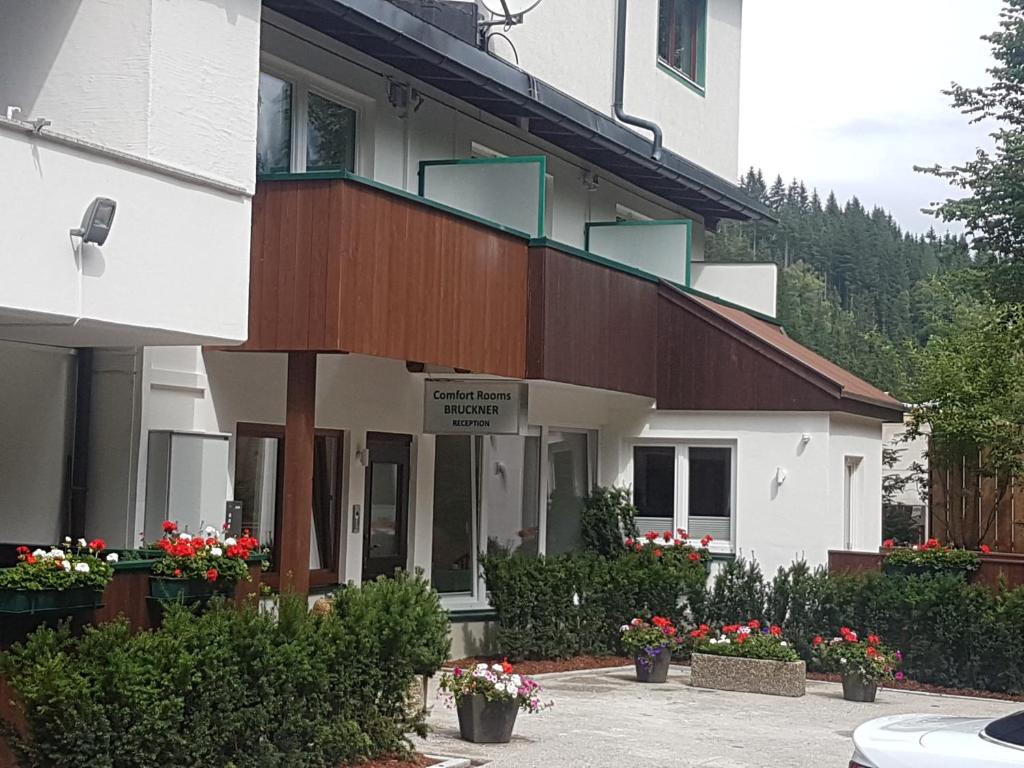 a building with flowers in front of it at Comfort Rooms Bruckner in Bad Gastein