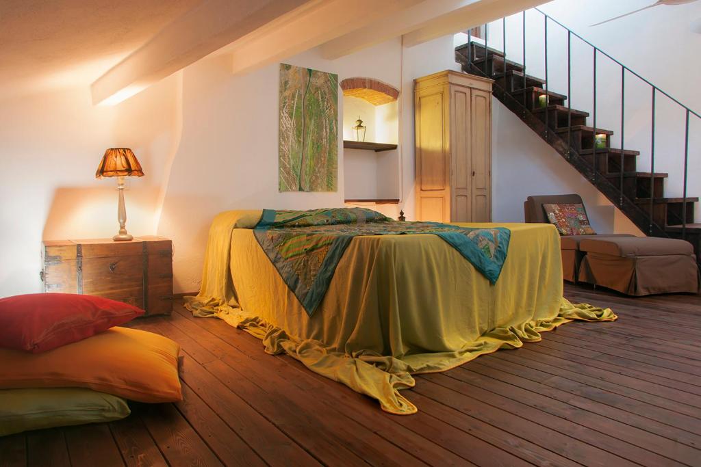 a bedroom with a bed in the middle of a room at Locanda Antico Borgo in Civitella in Val di Chiana