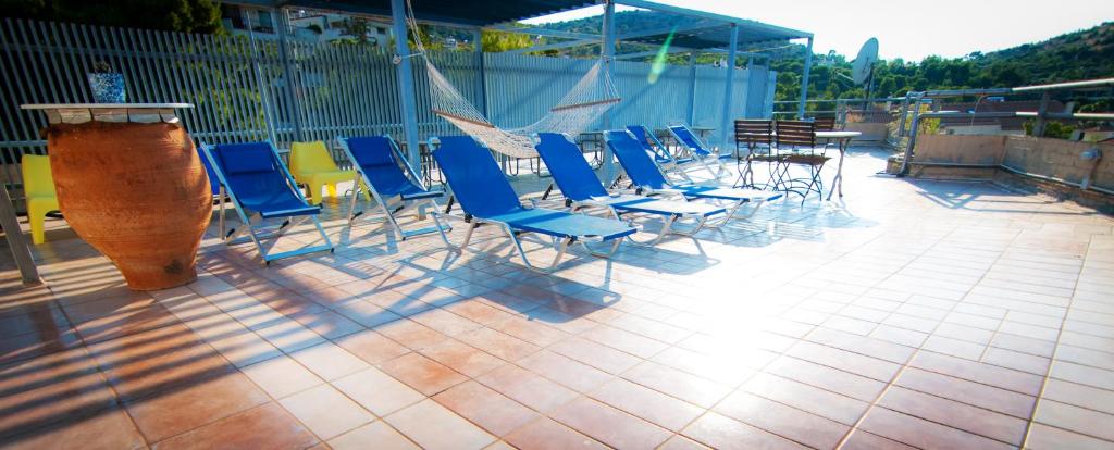 a group of chairs and tables on a patio at Apollonia Hotel Apartments in Varkiza