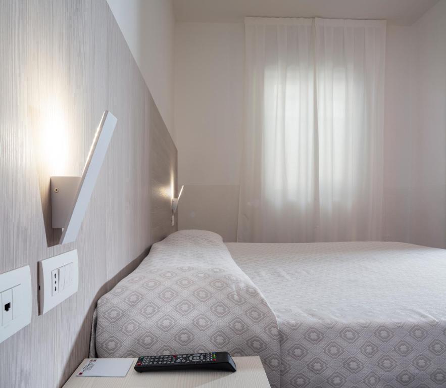 Postel nebo postele na pokoji v ubytování Alfa Fiera Hotel