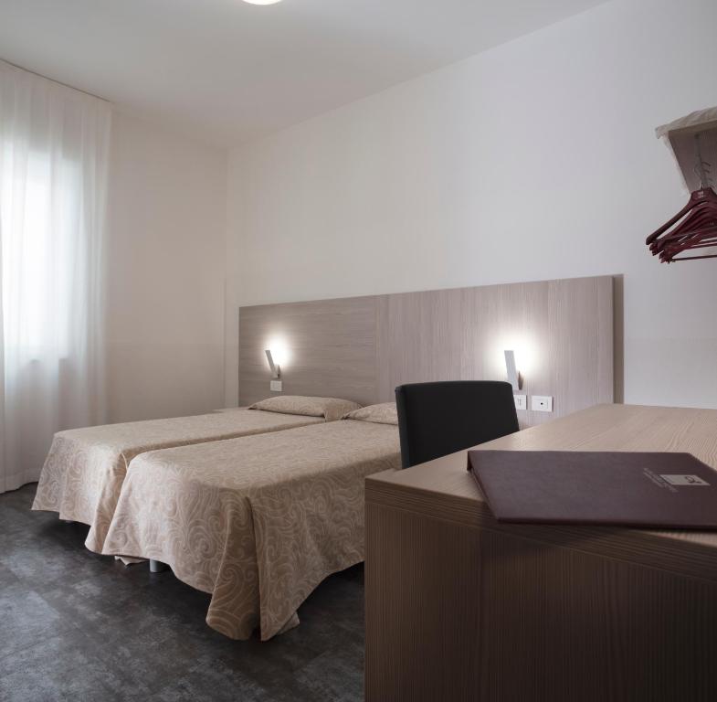 Postel nebo postele na pokoji v ubytování Alfa Fiera Hotel