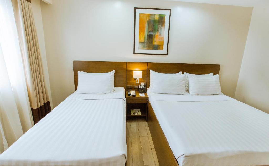 Postel nebo postele na pokoji v ubytování Golden Prince Hotel & Suites