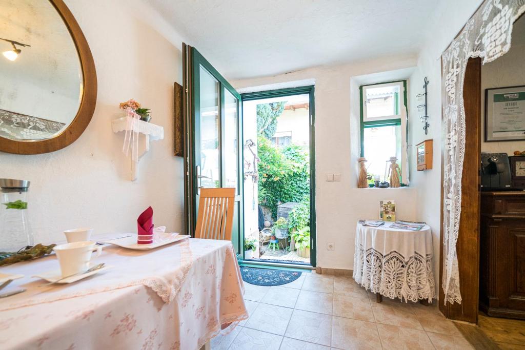 a dining room with a table and a mirror at Laubgassl in Mörbisch am See