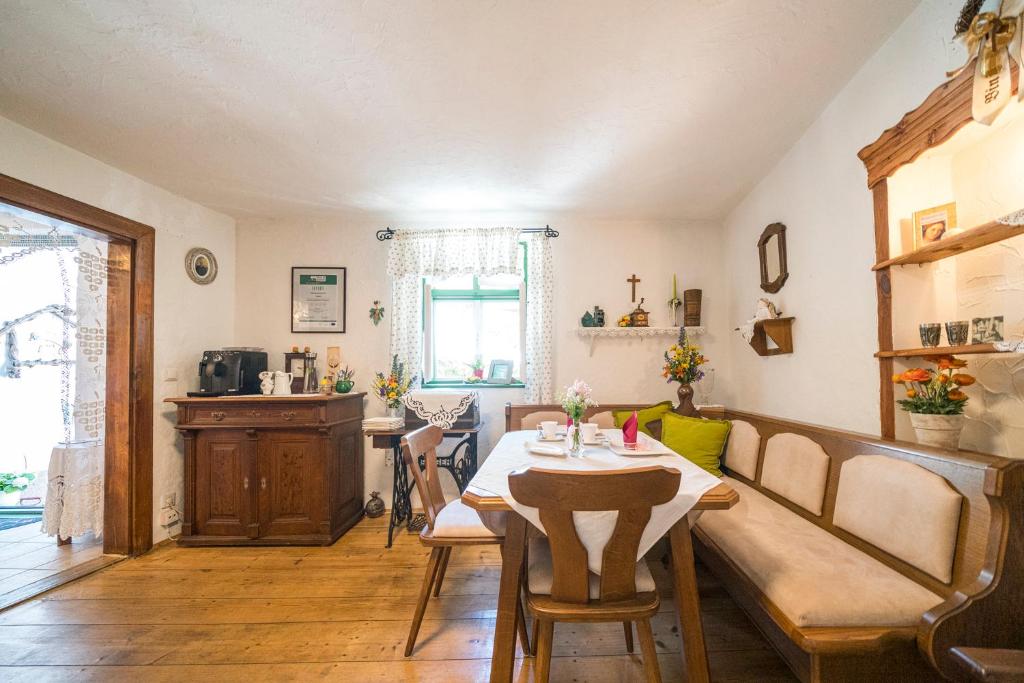 a dining room with a table and a couch at Laubgassl in Mörbisch am See