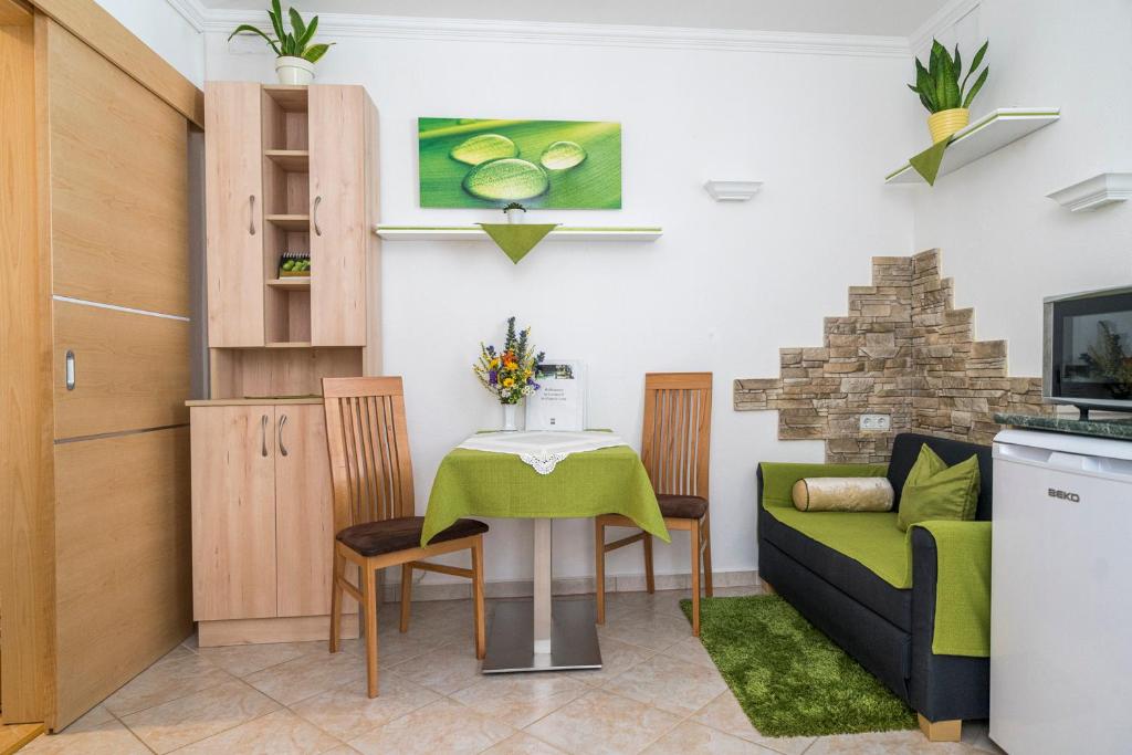 a living room with a table and a couch at Laubgassl in Mörbisch am See