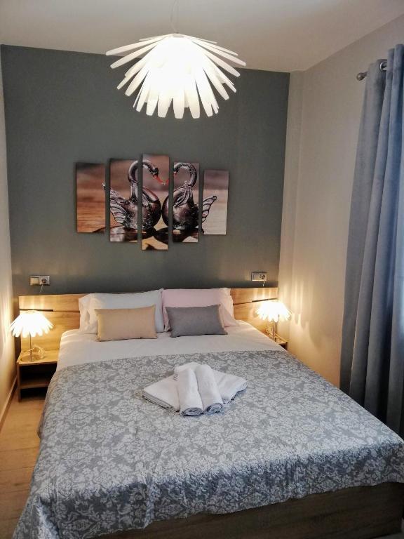 a bedroom with a large bed with a light above it at Haus Viktoria 2 in Limenas