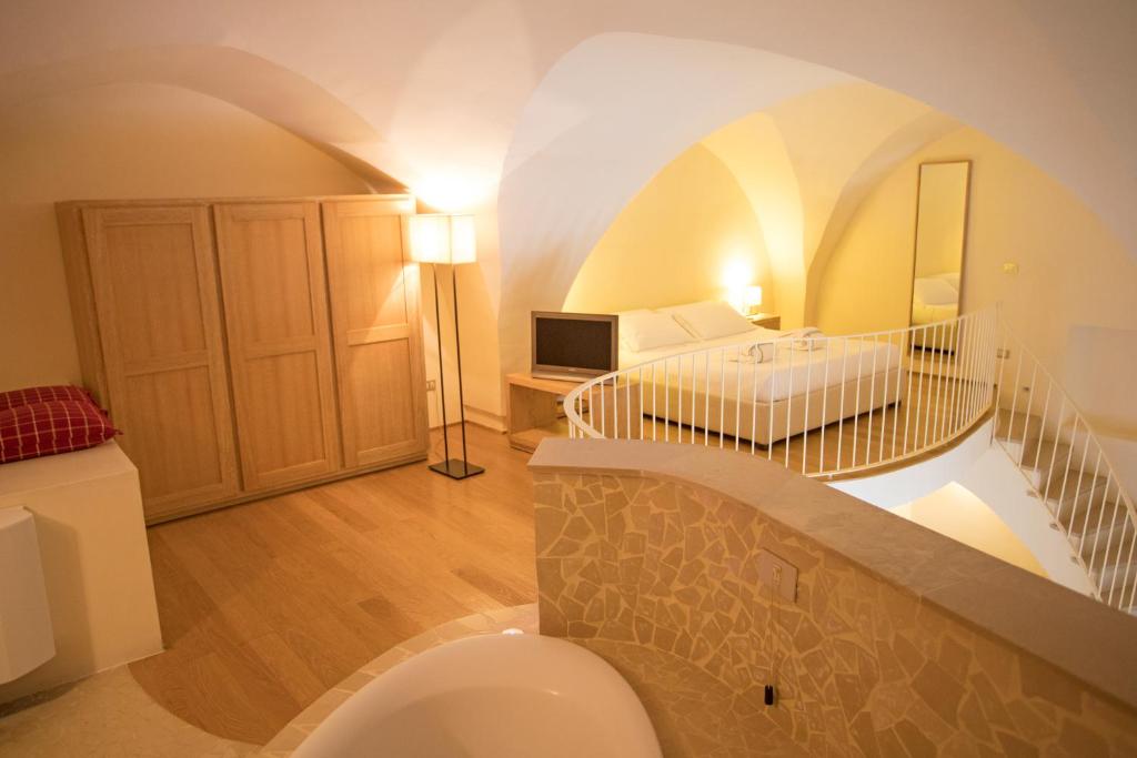 Кровать или кровати в номере La Sommità Relais & Chateaux