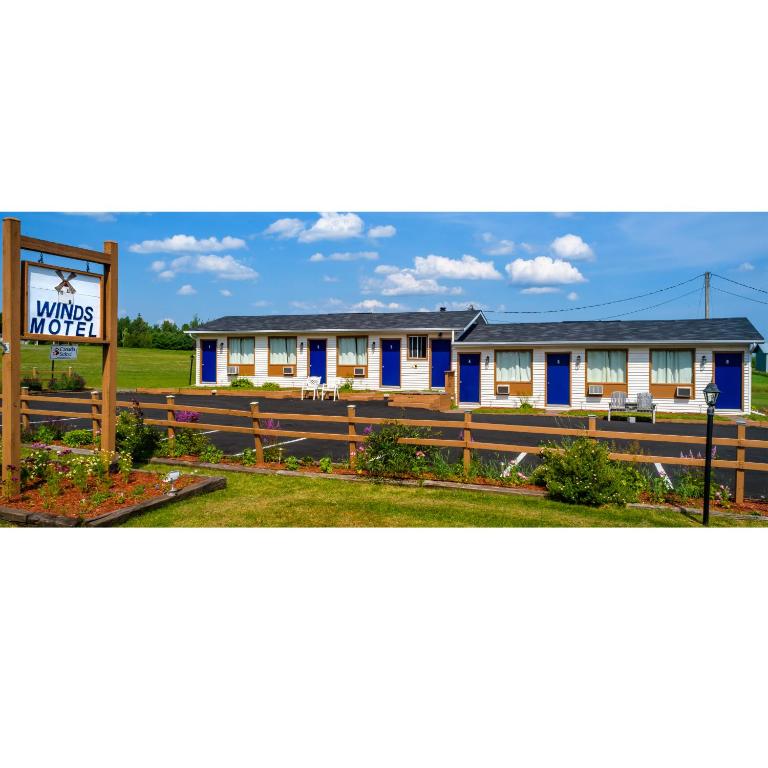 a motel with a sign in front of it at Winds Motel in Montague