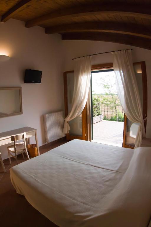 Postel nebo postele na pokoji v ubytování Agriturismo Fiumi Uniti