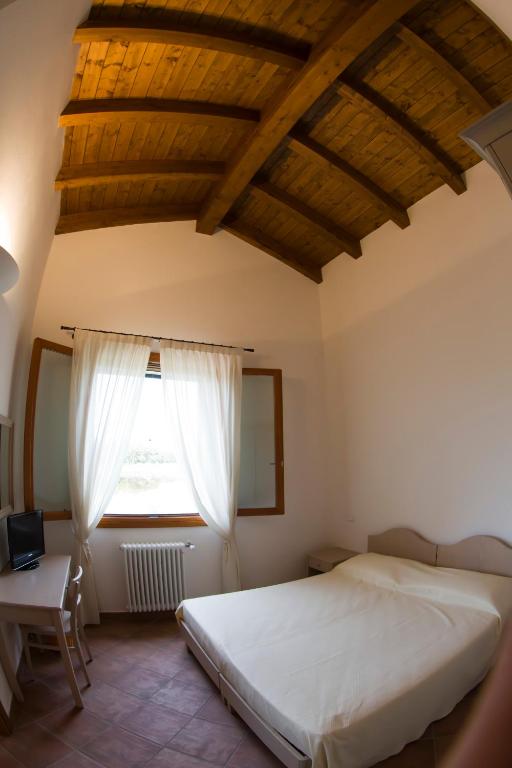 Postel nebo postele na pokoji v ubytování Agriturismo Fiumi Uniti