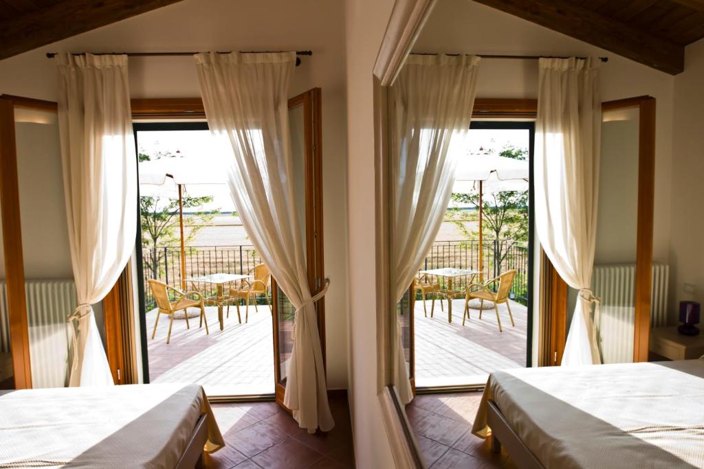 Postel nebo postele na pokoji v ubytování Agriturismo Fiumi Uniti