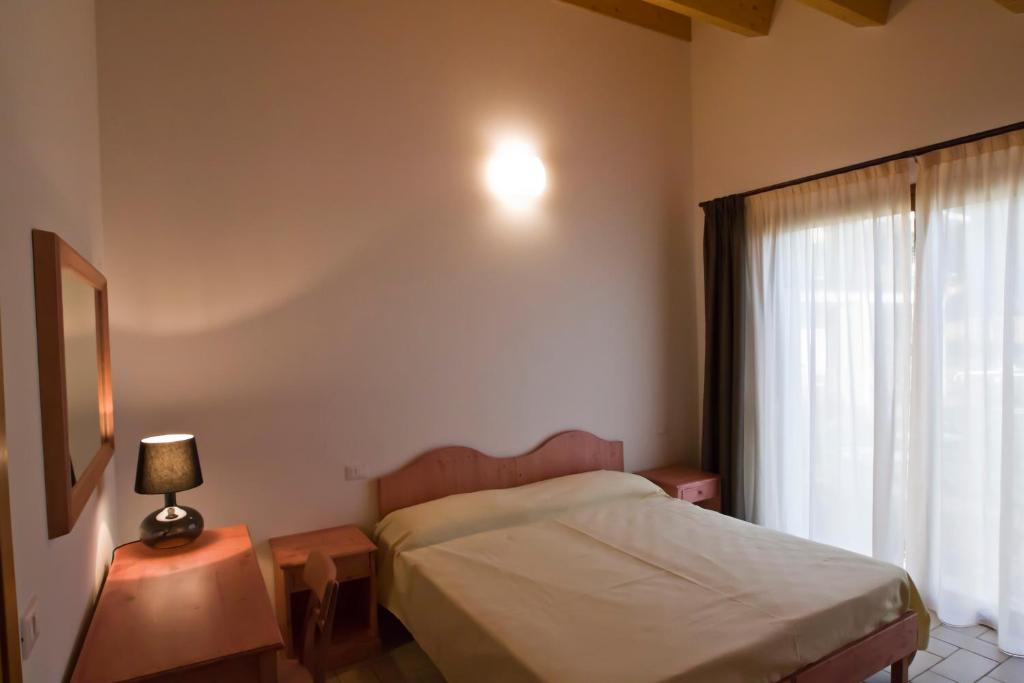 Postel nebo postele na pokoji v ubytování Agriturismo Fiumi Uniti