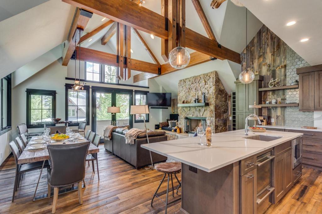 an open kitchen and living room with wooden ceilings at Aussie Elegance at Slopeside in Silverthorne