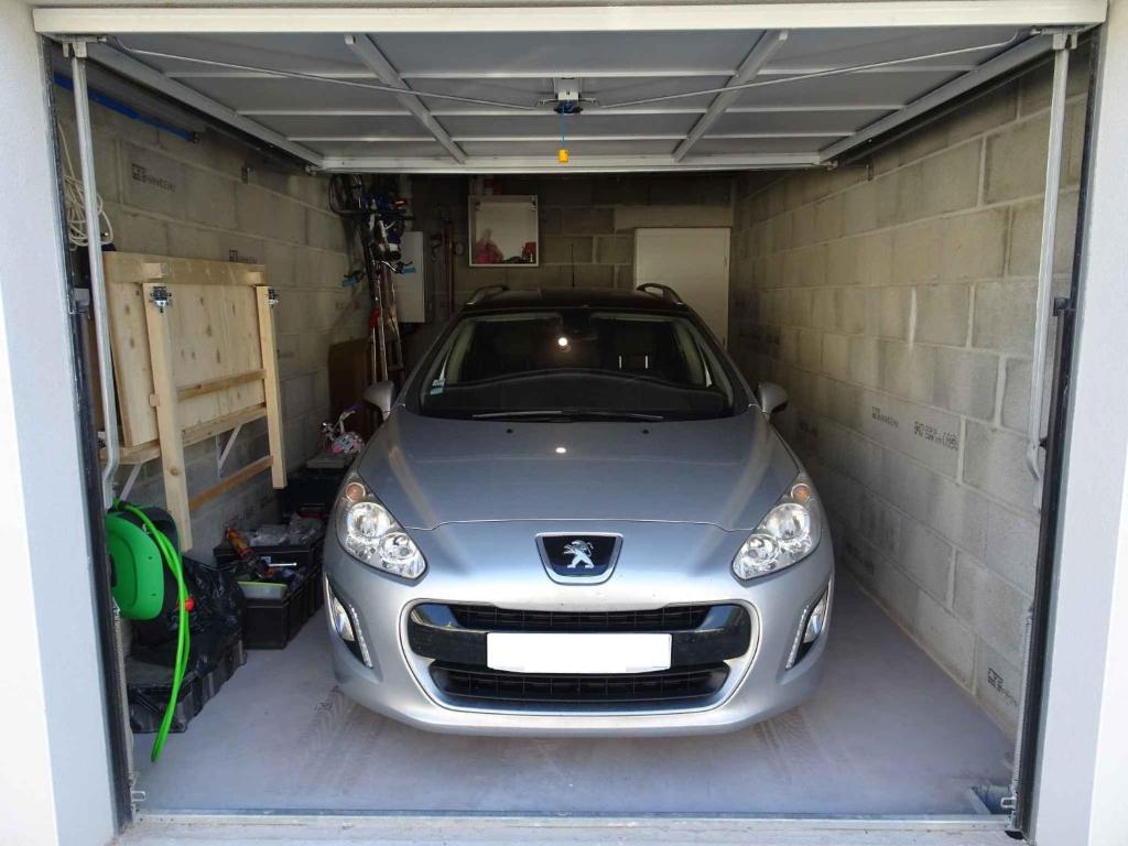 a silver car is parked in a garage at Villa du Cabestan in Andernos-les-Bains