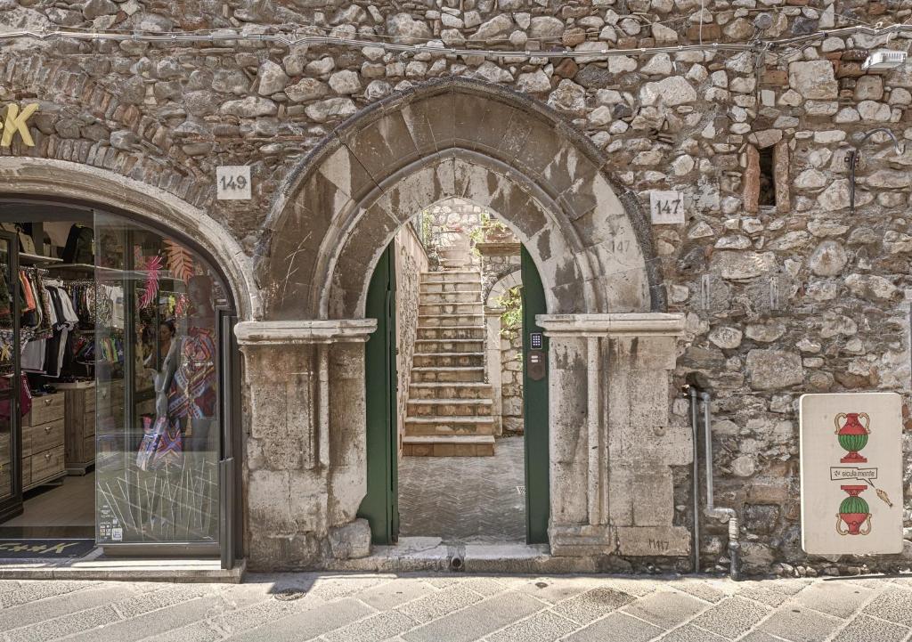 an entrance to a stone building with an arch at Relais 147 - Luxury b&b in Taormina