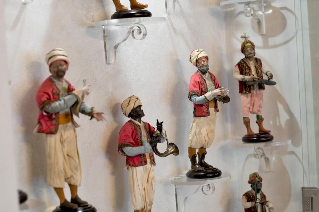 a group of figurines of men in a bathroom at Relais 147 - Luxury b&b in Taormina