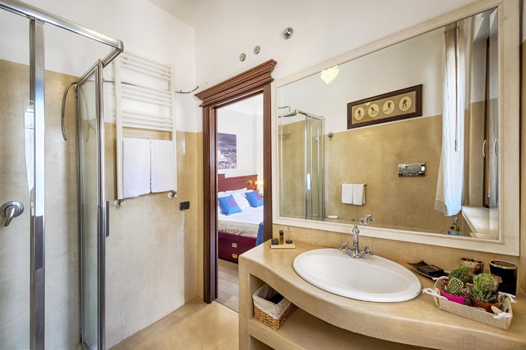 a bathroom with a sink and a shower at Relais 147 - Luxury b&b in Taormina
