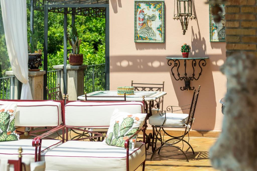 a patio with tables and chairs on a patio at Relais 147 - Luxury b&b in Taormina