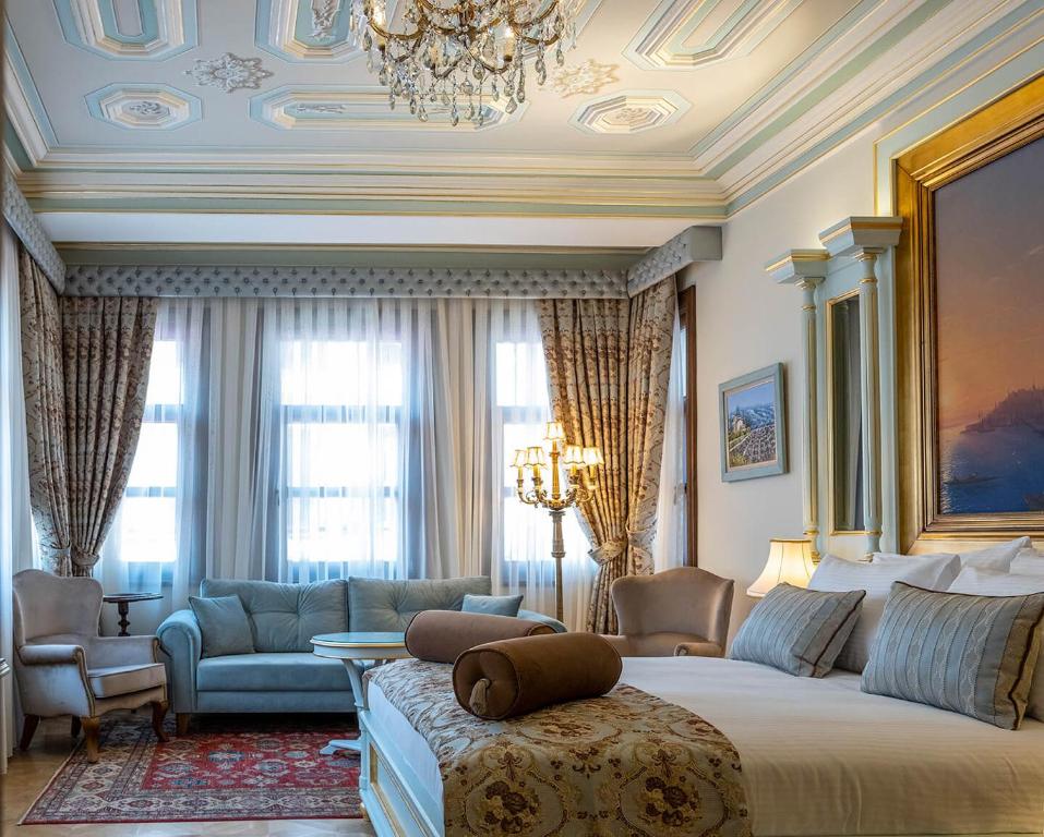 a bedroom with a large bed and a living room at Ortaköy Hotel in Istanbul